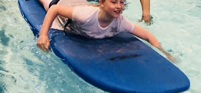 Child on Surf board in Forres Swimming pool